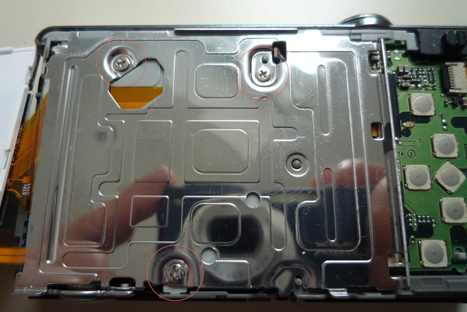 Panasonic Lumix DMC-FS62 digital camera disassembly - metal plate showing screws
