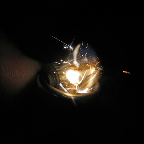 1/10000 sec shutter speed exposure of a lighter being lit, with the gas frozen in time as it begins to ignite